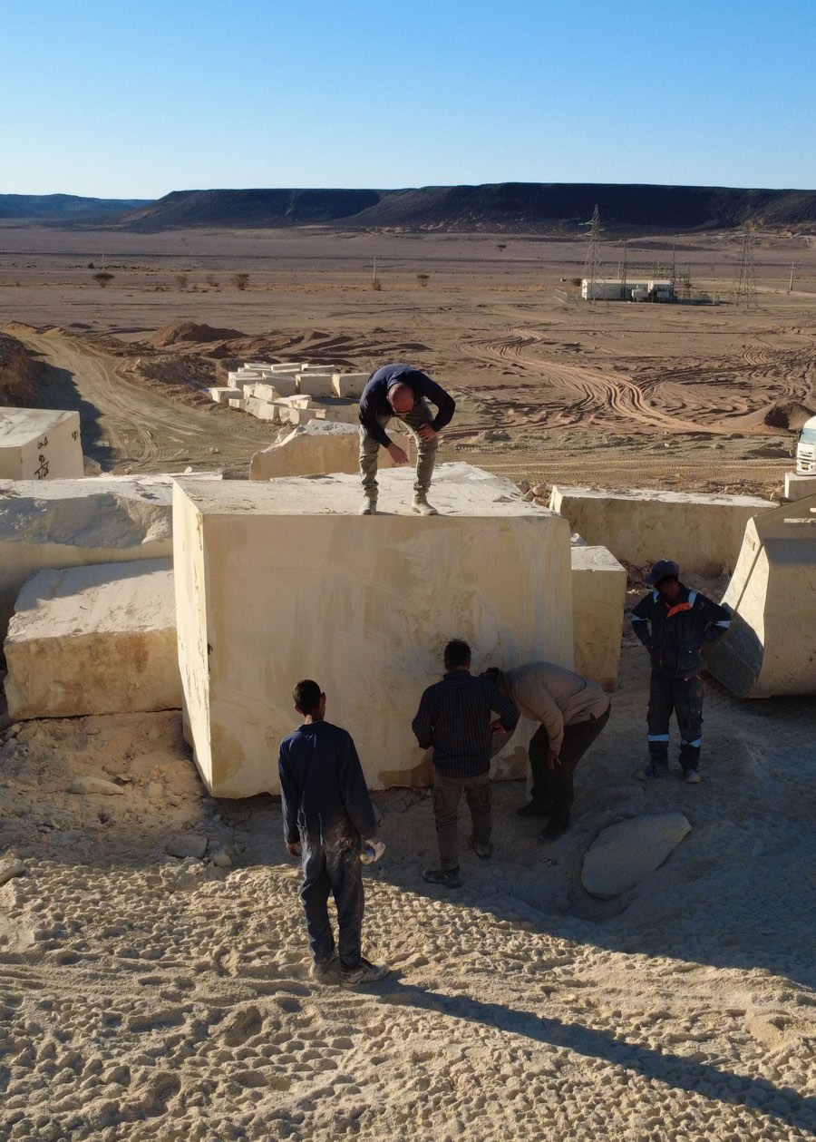Inspecting a Golden Yellow Limestone block at the quarry